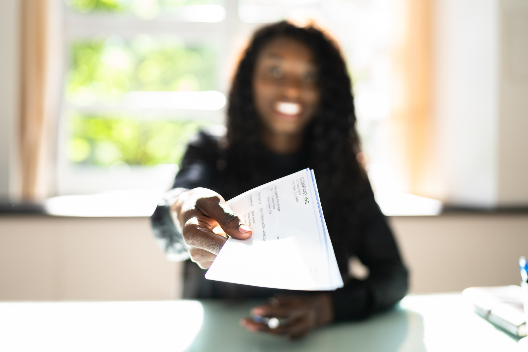 African Business Woman Giving Paycheck